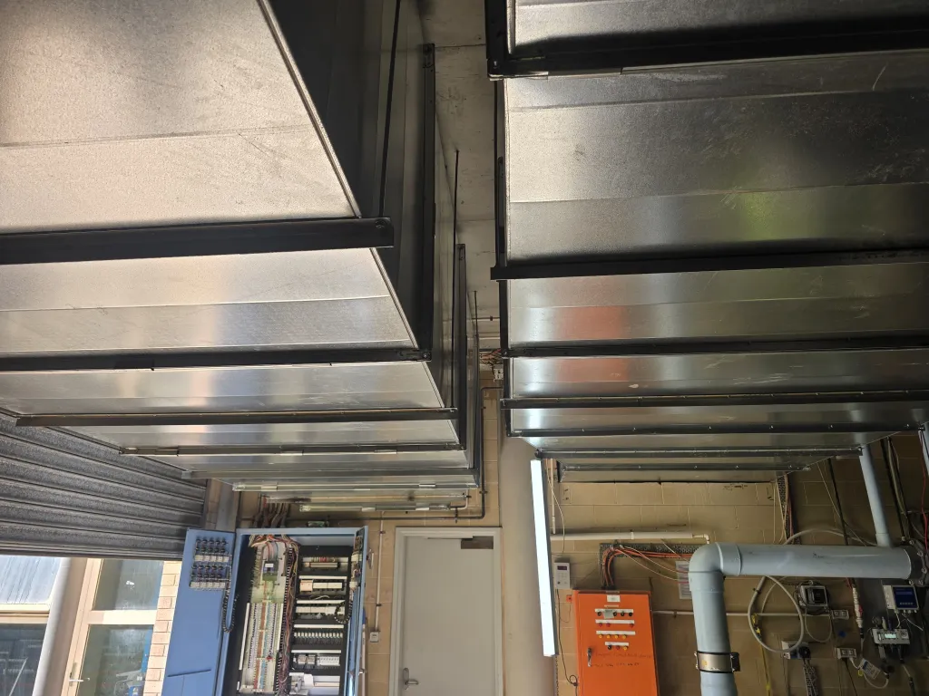 Rectangular supply ductwork installed across the plant room ceiling