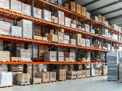 Pallet racking stacked with boxed goods in a dry storage warehouse