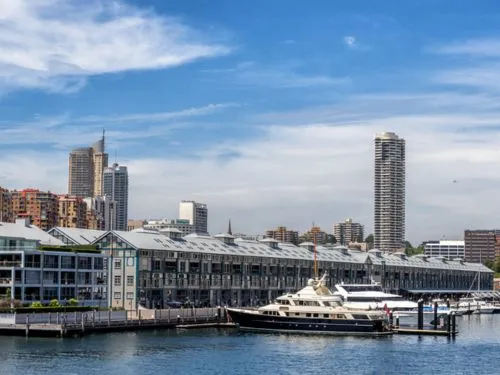 Waterfront wharf apartment buildings with Sydney city towers behind
