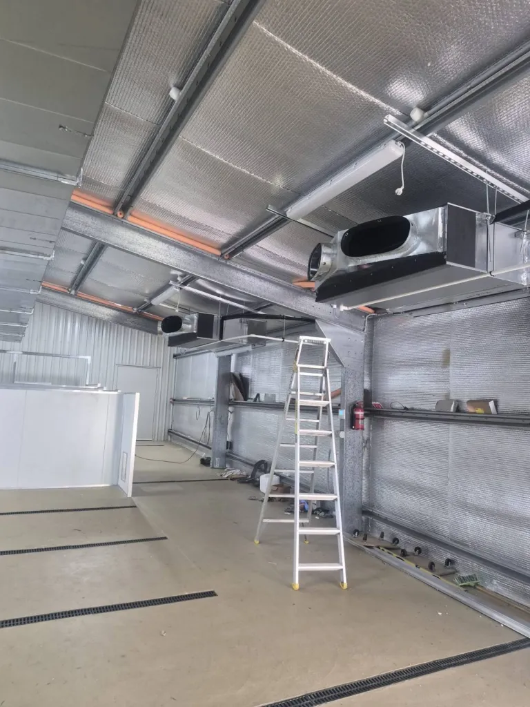 Ceiling-mounted ventilation units and ductwork installed in a kennel building